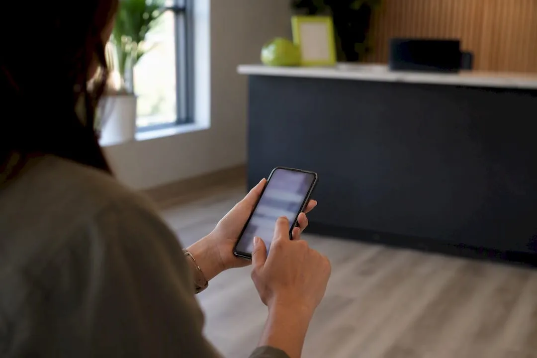 Hand holding smartphone for confirmation text